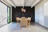 Modern home with Dining Room, Track Lighting, Table, Chair, Accent Lighting, and Ceramic Tile Floor. Dining Room - operable louvers at stair, original Jose Moya del Pino cityscape mural, Vibia Rythm light, Hermés table and chairs, Fleetwood sliding doors to deck Photo 10 of Lyon Residence