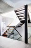 Modern home with Staircase, Wood Tread, Wood Railing, and Glass Railing. Walnut and Steel stair connecting all floors Photo 2 of Lyon Residence