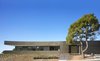 The exterior of the house is wrapped in anodized aluminum slats held in place by a high-performance strength tape used in aircraft production. Photo of Double Stick modern home
