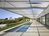 A 25-foot cantilevered trellis protects the southern patio and pool from neighbors above and frames sweeping uninterrupted views of the Los Angeles Basin to the south. Photo 3 of Double Stick modern home