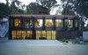 The building addition’s most distinct feature is its metal screen façade. The screens open like shutters for clear views of the property, and when shut, allows for privacy, sun shading and environmental control. Photo 2 of Morgan Phoa Library and Residence modern home