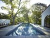 Lined with tiles from the historic Jackling House, designed by George Washington Smith and once owned by Steve Jobs, the pool addition gave reason to further enjoy the southern California climate. Photo 5 of Morgan Phoa Library and Residence modern home