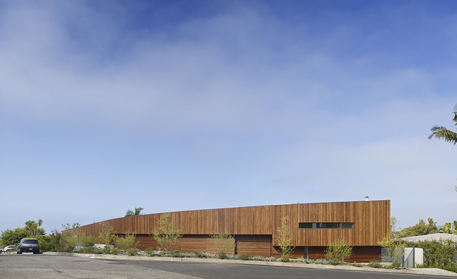 The street façade is clad in 1x2 Ipe wood rain screen to offer a quiet, unobtrusive face to the neighborhood with strategic slot windows that give glimpses of what lies beyond.
