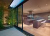 Standard black anodized aluminum sliding window and door systems optimize the flow of natural sunlight, and air through the plan’s open spaces. Photo 3 of Nightingale Residence modern home