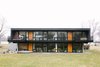 Window-filled, back exterior faces Bassett Creek Photo of The Soulek House modern home