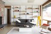 Lower level den with original fireplace and shelving. Photo 13 of The Soulek House modern home
