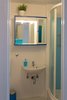 The tiles on the walls and in the shower were painted with yacht paint. The floor tiles were covered with a layer of garage floor epoxy paint. Photo 11 of Shabby Chic Beach Cottage modern home
