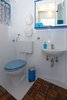 Floor decking instead of a rug gives this tiny bathroom a spa feel. Photo 13 of Shabby Chic Beach Cottage modern home