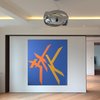 Sliding art wall with a walnut surround. Photo of At Home With Art modern home