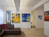 Modern home with Living Room, Sectional, Accent Lighting, Ceiling Lighting, and Light Hardwood Floor. The bedroom is enclosed by large scale sliding panels which double as art walls. The walls may be closed while entertaining guests and opened to completely integrate the bedroom and living room into one open space. Photo 6 of Art and Light