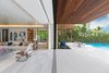 Floor to ceiling sliding glass doors pocket and disappear allowing a natural flow from indoor to outdoor. Photo 4 of North Bay Road Residence modern home