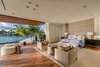 The master bedroom features direct views of the water, and is also designed for indoor-outdoor living. Photo 6 of North Bay Road Residence modern home
