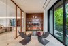 The home's office is adjacent to the living room with views of lush landscape. Photo 8 of North Bay Road Residence modern home