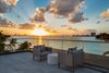 An outdoor seating area on one of the home's many balconies has great views of the sunset. Photo 10 of North Bay Road Residence modern home