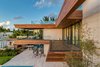 Spacious balconies and deep overhangs allow for easy entertaining. Photo 11 of North Bay Road Residence modern home