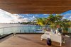 A second master bedroom comes with spacious private balcony and bay views. Photo 12 of North Bay Road Residence modern home