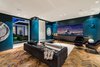 The media room features a herringbone patterned flooring made of reclaimed barn wood. Photo 3 of Ponce Davis Residence modern home