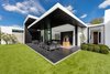 One of the living rooms completely opens up to a covered outdoor seating area. Photo 9 of Ponce Davis Residence modern home