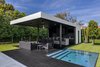 The outdoor cabana is located next to an underground hot tub. Photo 12 of Ponce Davis Residence modern home