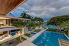 Modern home with Outdoor, Back Yard, Infinity Pools, Tubs, Shower, Trees, Large Pools, Tubs, Shower, Grass, Stone Patio, Porch, Deck, Large Patio, Porch, Deck, and Pavers Patio, Porch, Deck. From one of the home's master suites, one can see the oversized pool, reflecting ponds, the master balcony and the water. Photo 2 of Palm Island Residence