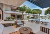 Modern home with Outdoor, Back Yard, Trees, Stone Patio, Porch, Deck, and Large Patio, Porch, Deck. The main outdoor patio has plenty of shade provided by the large overhangs. Photo 3 of Palm Island Residence
