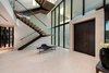 Modern home with Staircase, Wood Tread, and Glass Railing. The statuesque staircase made of metal, wood and glass sits just off the main entrance. Photo 6 of Palm Island Residence