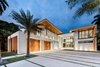 Modern home with Outdoor, Front Yard, Large Patio, Porch, Deck, Trees, Stone Patio, Porch, Deck, Pavers Patio, Porch, Deck, and Landscape Lighting. Tropical elements such as Ipe wood, stone, glass, and water features are found throughout the exterior of the home. Photo 13 of Palm Island Residence