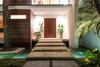 Modern home with Wood, Swing Door Type, Exterior, Outdoor, Front Yard, Trees, Raised Planters, Small Pools, Tubs, Shower, Stone Patio, Porch, Deck, and Landscape Lighting. Large limestone steps take you over a reflecting pond toward the front door. Photo 2 of Casa Ischia