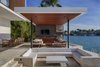 Modern home with Sectional, Recessed Lighting, Limestone Floor, Back Yard, Stone Patio, Porch, Deck, Kitchen, Wood Cabinet, Stone Tile Backsplashe, Drop In Sink, Range Hood, and Range. A conversation pit located by the pool brings a touch of mid-century to this modern oasis. Photo 8 of Casa Ischia
