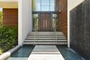 One of three reflecting ponds can be found at the front entrance along with a large waterfall giving this contemporary home a tropical modern feel. Photo 2 of Rivo Alto Residence modern home