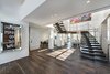 The central design element of the home is a floating, grand elliptical staircase, utilizing steel, wood and curved a Starphire glass handrail, all under a stunning 300 square foot skylight. Photo 3 of Rivo Alto Residence modern home