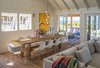 The dining area is furnished with a 10 foot long, rough hewn recycled timber table and contrasting classic Eames chairs. Photo 9 of Corkin House modern home