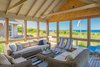 A spacious three-sided screened porch, conveniently located adjacent to the living/dining/kitchen area, is nestled on the edge of a dune overlooking the refreshing waters of Cape Cod Bay. Photo 4 of Corkin House modern home