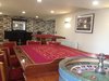 The casino room:
What is a celebration without a little fun and games at the casino? The casino facility comes complete with a casino room with Roulette and Black Jack tables which builds the excitement of the time spent in the room which gives the feel of James Bond evenings. The bonus news is that the cost of hiring a professional croupier is included in the price of renting the Hollywood house. Refer to this site for more information:
http://www.bonus-senza-deposito.biz/news-casino/.
This room also has a cocktail bar to add on to the mood of the evening and also a pinball machine.
Photo 5 of Hollywood House modern home