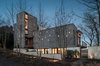 Modern home with Exterior, Wood Siding Material, Flat RoofLine, Metal Roof Material, House Building Type, Butterfly RoofLine, Stucco Siding Material, and Beach House Building Type. Front Elevation with Glimpse of Bay Photo 2 of House on Little Round Bay