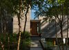 Modern home with Exterior, Flat RoofLine, Metal Roof Material, Wood Siding Material, House Building Type, Butterfly RoofLine, and Stucco Siding Material. Front Door Photo 4 of House on Little Round Bay