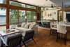 Modern home with Living Room, Wood Burning Fireplace, Medium Hardwood Floor, Sofa, and Pendant Lighting. View of Living/Dining From Entry Photo 5 of House on Little Round Bay