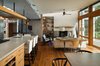 Modern home with Living Room, Wood Burning Fireplace, Sofa, Track Lighting, Chair, Medium Hardwood Floor, and Pendant Lighting. View back towards Entry and Stair Photo 9 of House on Little Round Bay