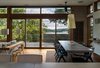 Modern home with Dining Room, Table, Pendant Lighting, Medium Hardwood Floor, and Chair. View to Deck & Little Round Bay Photo 10 of House on Little Round Bay