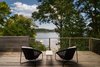 Modern home with Outdoor, Trees, Wire Fences, Wall, Decking Patio, Porch, Deck, Horizontal Fences, Wall, Back Yard, Wood Patio, Porch, Deck, and Shrubs. Deck overlooking Little Round Bay Photo 12 of House on Little Round Bay