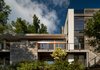 Modern home with Exterior, Butterfly RoofLine, Flat RoofLine, Stucco Siding Material, Metal Roof Material, House Building Type, Wood Siding Material, and Beach House Building Type. Bay Elevation Photo 13 of House on Little Round Bay