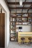 One of the family’s favorite rooms in the house is the library. Young’s wife is an avid reader and founded a children's literacy nonprofit here in Orlando. The couple needed a space for everyone’s books, and finding a place where they could display them side-by-side was important.
The bookshelf, part of a larger shelving grid, is built around a bright yellow piano. The piano was Young’s wife's when she was growing up and it was originally a very boring, oak brown. “We wanted it to be the signature feature of the room and painting it yellow is always a fun surprise when you walk in the room. This is the room you can find us in most nights playing board games, playing piano, and drinking wine.” Photo 19 of 1600 Lakeside modern home