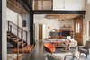 The long hallway from the kitchen to the master bedroom is often used as a racetrack for scooters or cardboard box bobsledding. The exposed steel support beams are at the heart of the home, and the project's design. Photo 20 of 1600 Lakeside modern home