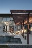 Modern home with Exterior. The sun-shade beside the pool plays with the horizontal and vertical repetition of the exposed beams that are not only the heart of the home's construction but also its design. Photo 10 of 1600 Lakeside