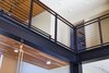 This detail speaks to the heart of Young's project: to play with exposed materials. Here, Young left the support beams exposed and they become the heart of the home.
He repeats the vertical and horizontal lines of this central structure in multiple applications outdoors, including the support of the concrete boardwalk, the pergola over the courtyard and the sun-shade beside the pool.
Here, you can also see the two totally different ceiling treatments. Upstairs is cherry plywood that has been lacquered and set in squares atop black-painted drywall. Downstairs the ceiling is tongue-in-groove Florida black cherry, which is used to define spaces. Photo 7 of 1600 Lakeside modern home