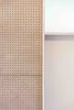 Modern home with Storage Room and Cabinet Storage Type. The cabinet is made out of perforated wood and laminated in light and playful colors. Photo 7 of CUSTOM LIVING