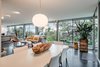 Modern home with Living Room, Dark Hardwood Floor, Recessed Lighting, Floor Lighting, Chair, Ottomans, Sectional, and Pendant Lighting. Back wall from dining area. Photo 5 of An Eduard Dreier Home asked $1.2M