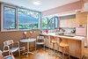 Modern home with Kitchen, Ceiling Lighting, Laminate Counter, Refrigerator, Range Hood, Recessed Lighting, Wood Cabinet, Drop In Sink, Wall Oven, and Vinyl Floor. Kitchen Photo 6 of An Eduard Dreier Home asked $1.2M
