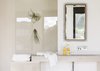Guests can enjoy the great views from the shower. The metal mirror was found at Q-Arte (Lisbon). The stone basin was designed by Ábaton and it was carved on the same stone as the floor. Photo 6 of micasaenlisboa modern home