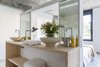 A wall behind the bed divides the bathroom from bedroom and is used as a side table for the bed. The chesnut top was designed by Abaton and the ceramic basins were designed and produced by Maria on her atelier Photo 12 of micasaenlisboa modern home